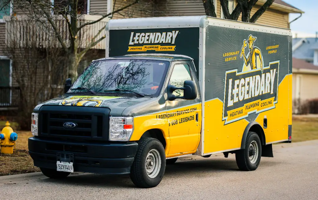 Legendary Service black and gold box truck parked on a North Shore residential street
