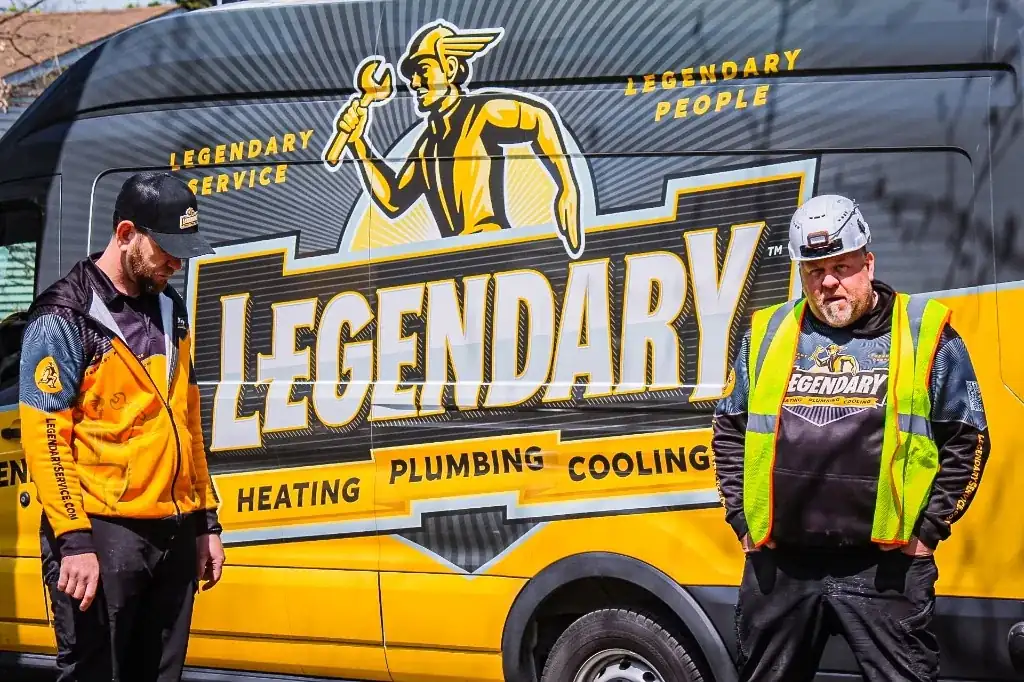 Legendary Service technicians with a black and yellow branded service van