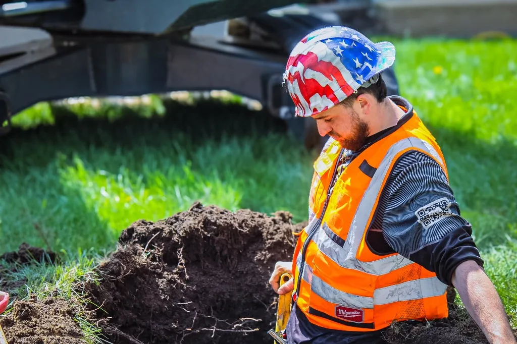 Legendary Service plumbing team working near excavation equipment